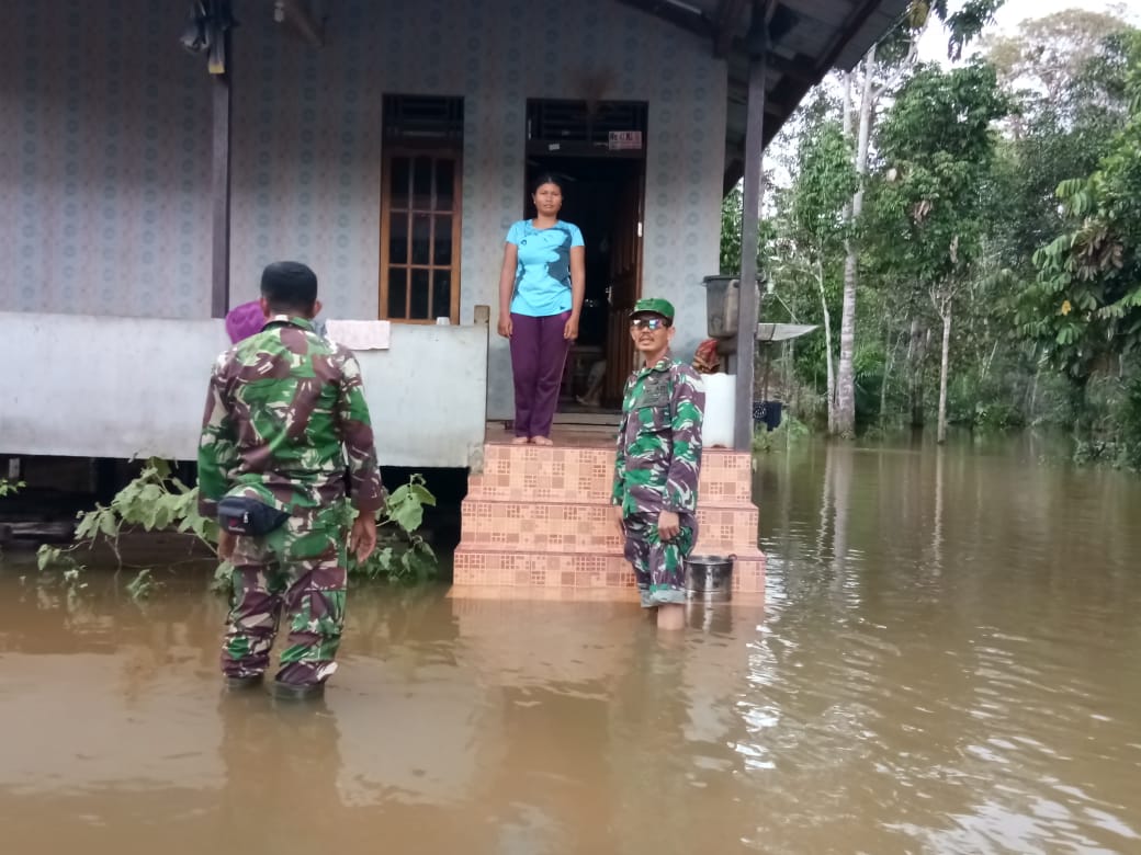 Foto---Danramil Kembayan melakukan evakuasi korban banjir, Senin (9/12) di Kecamatan Kembayan